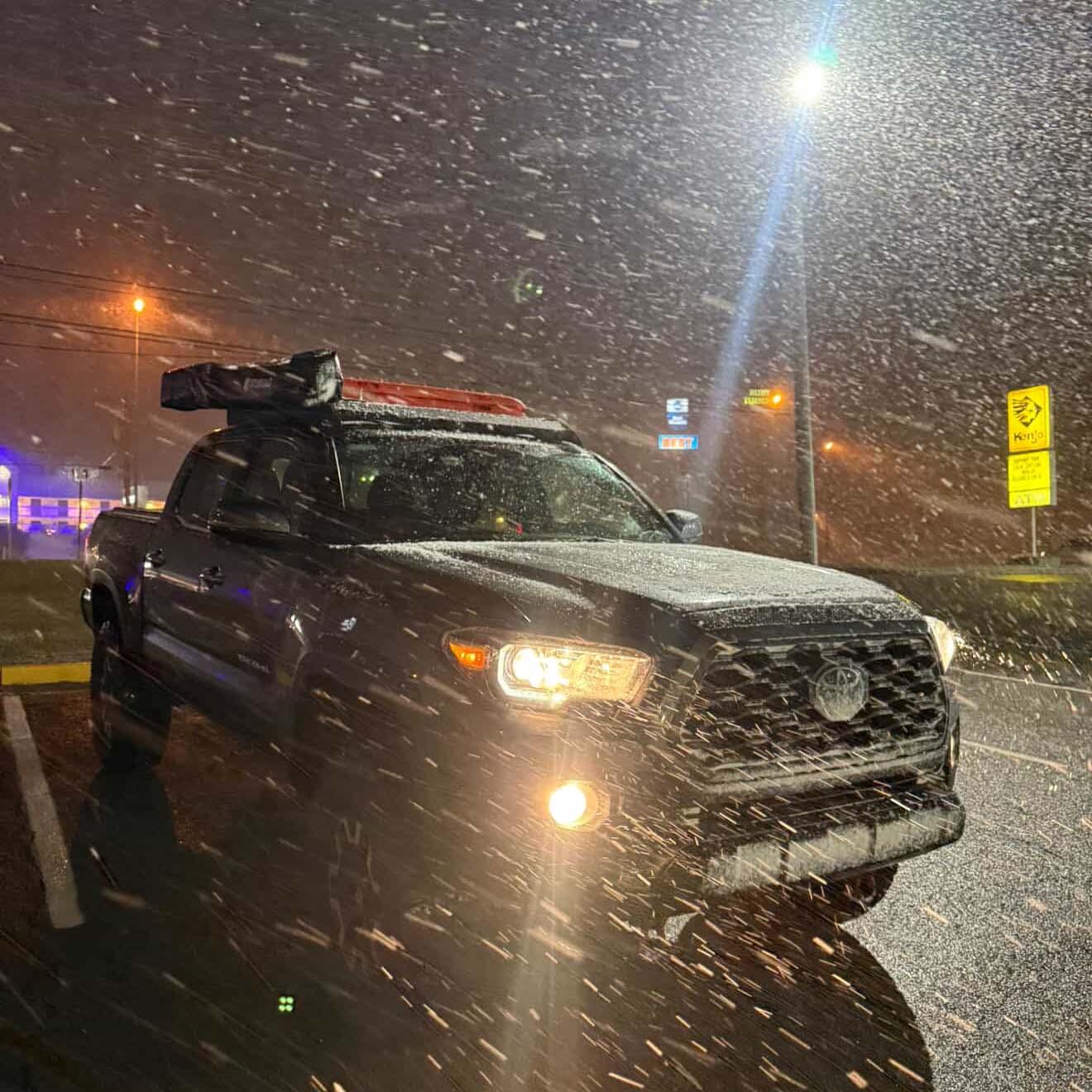 Black pickup truck in snowy winter conditions