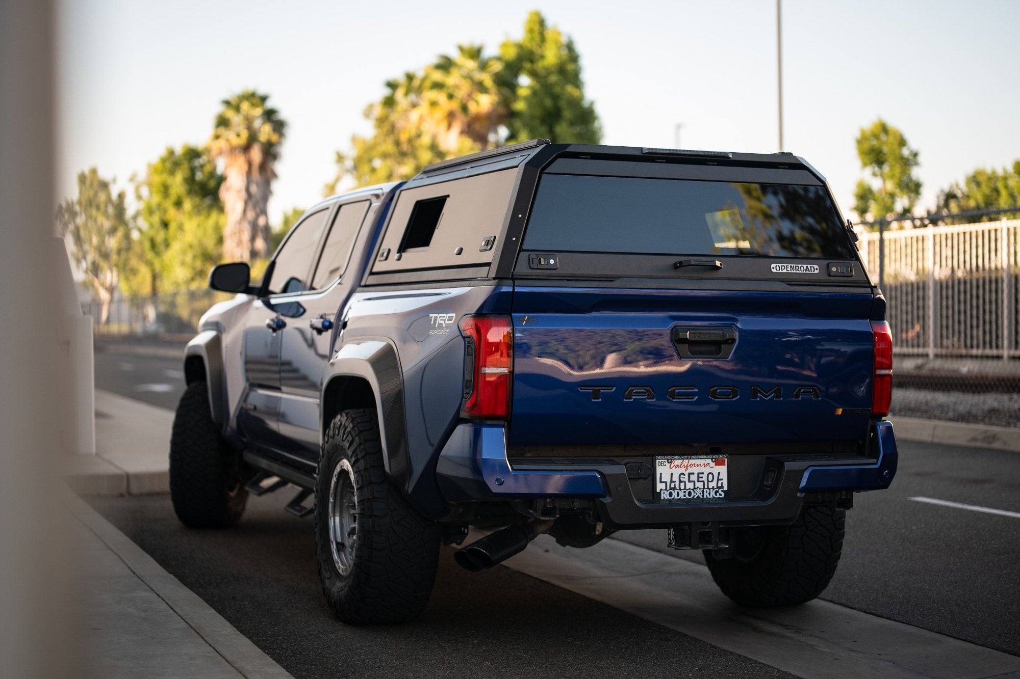OPENROAD sliding glass aluminum truck cap on a blue Toyota Tacoma